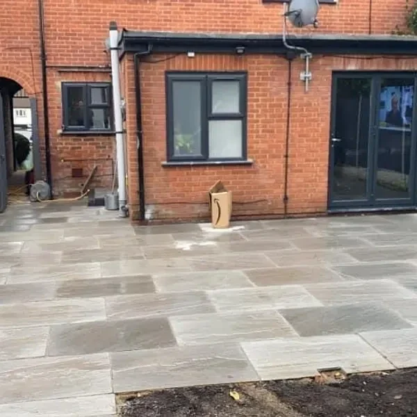Grey slab patio behind a house