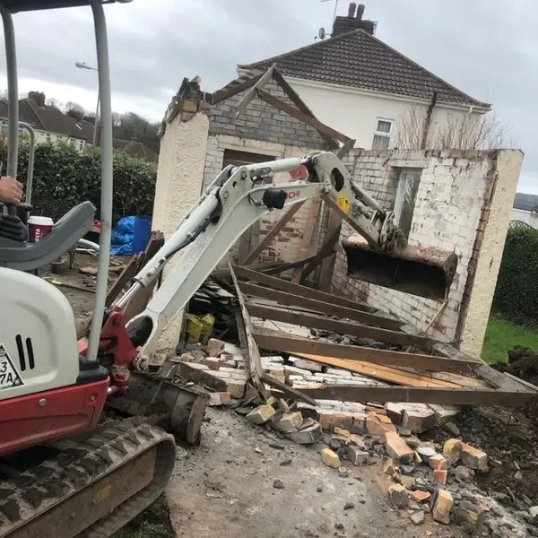 Digger breaking out an old structure