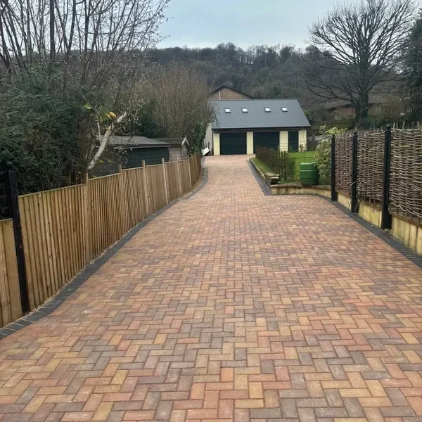 Long brindle block paving drive leading to a garage
