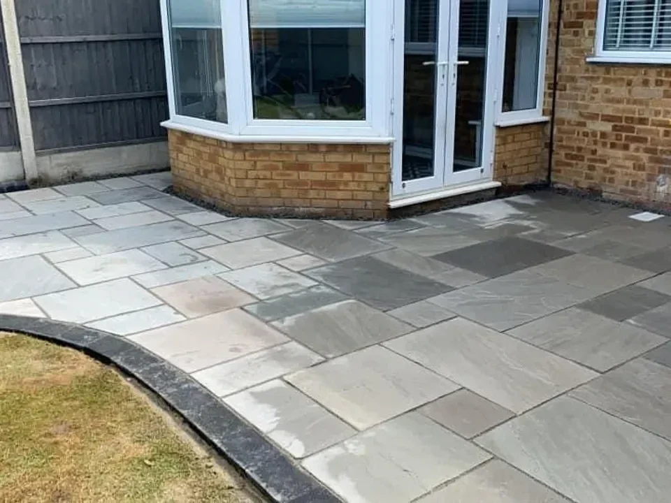 Grey slab patio around a bay window