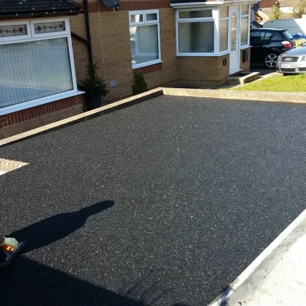 Black tarmac driveway in front of a house