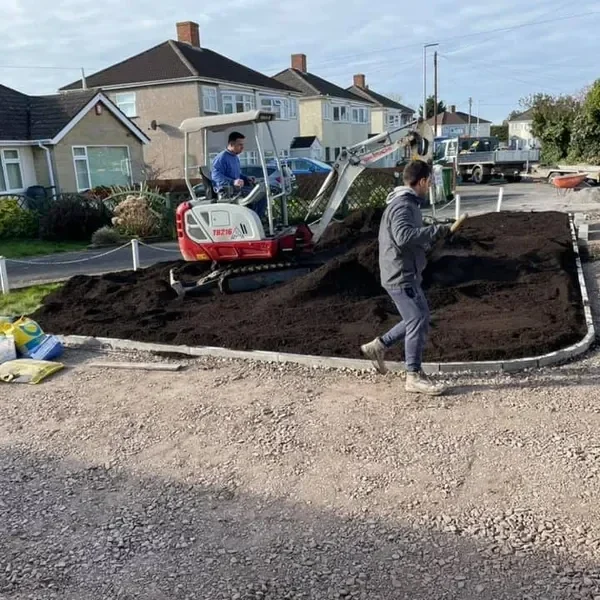 Mini digger levelling a front garden