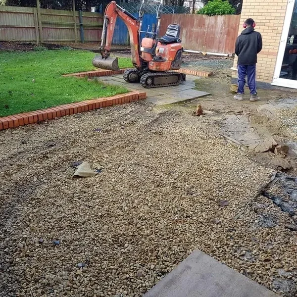 Digger excavating a back garden