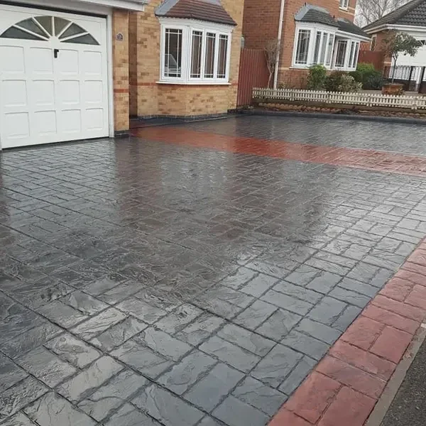 Charcoal brick-print imprinted concrete with a red border
