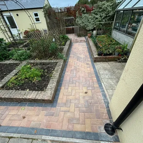 Block paved garden path between raised beds