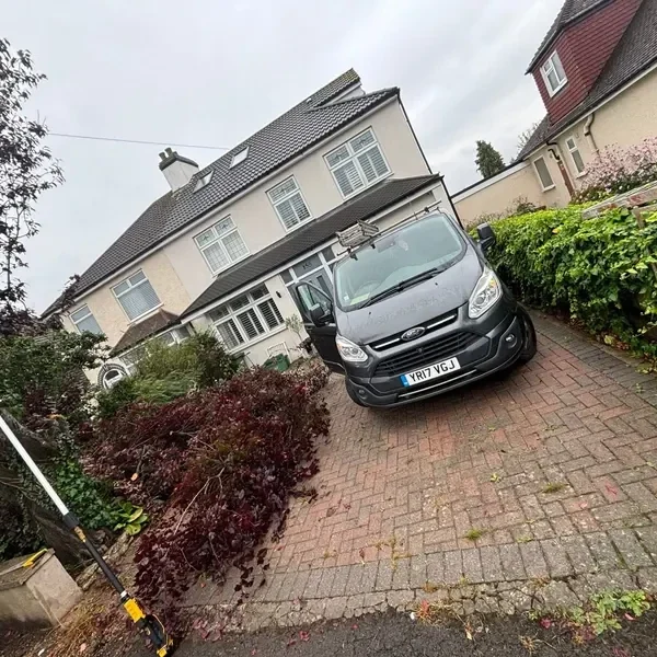 Red block paving driveway in front of a house