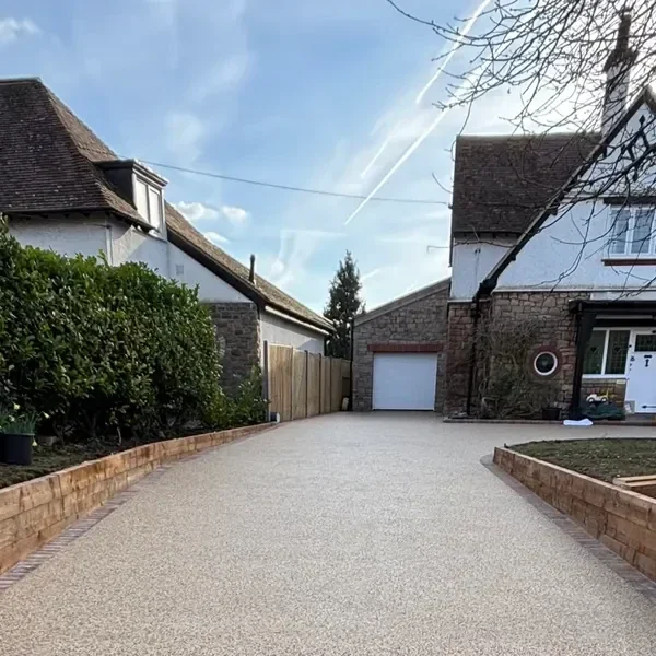 Long resin bound driveway leading to a garage