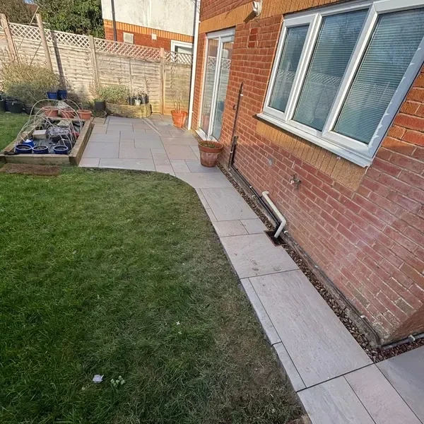 Slab patio wrapping around a house