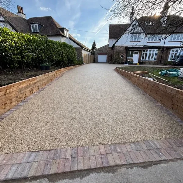 Resin bound driveway lined with low brick walls