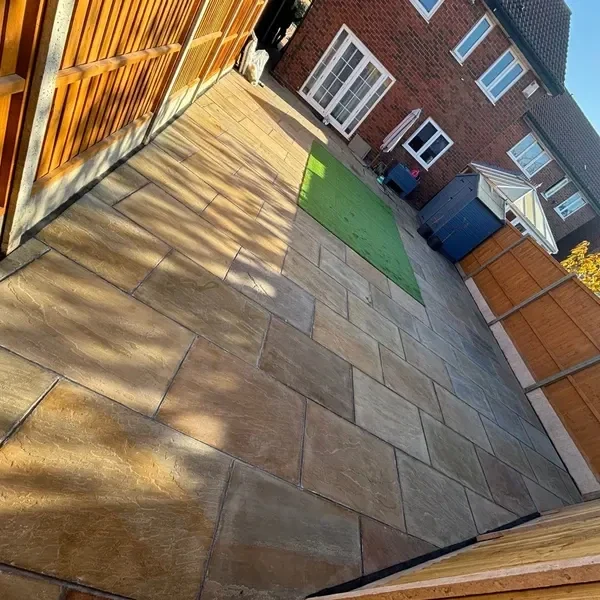 Buff slab patio with artificial grass