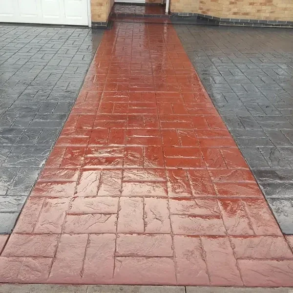 Charcoal imprinted concrete with a red centre path