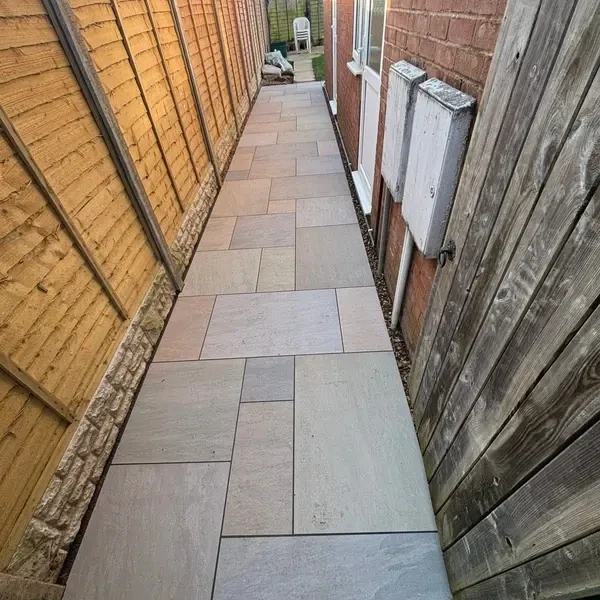 Narrow slab path down the side of a house
