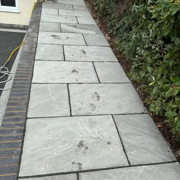 Grey slab path with a brick edge