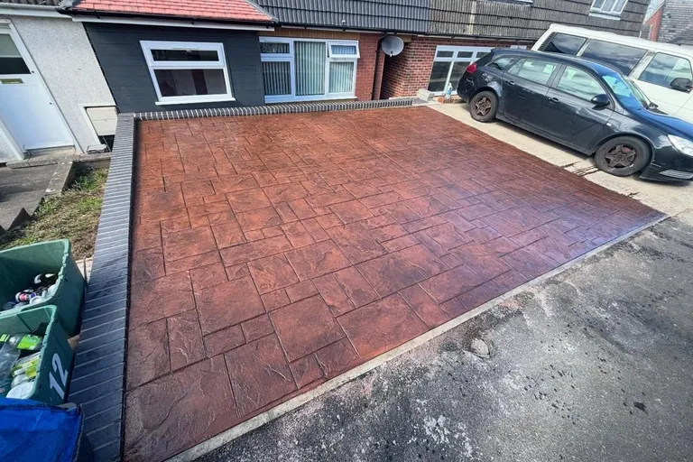Red imprinted concrete driveway laid by Smart Paving
