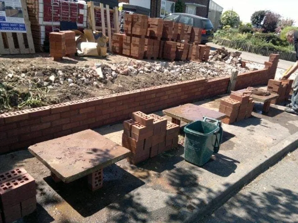 Bricklaying in progress on a garden wall