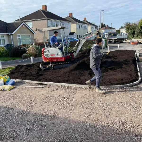 Mini digger levelling a front garden