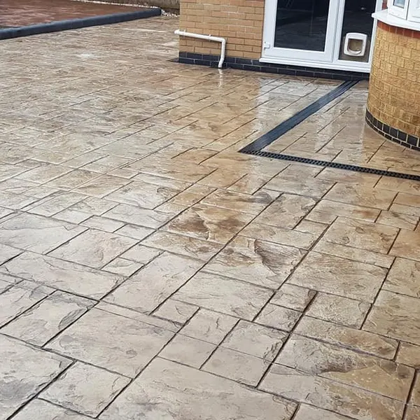 Buff ashlar-print imprinted concrete with a charcoal border