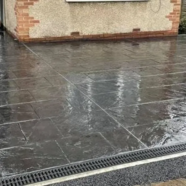 Charcoal imprinted concrete with a channel drain