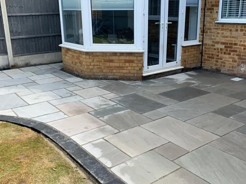 Grey slab patio around a bay window