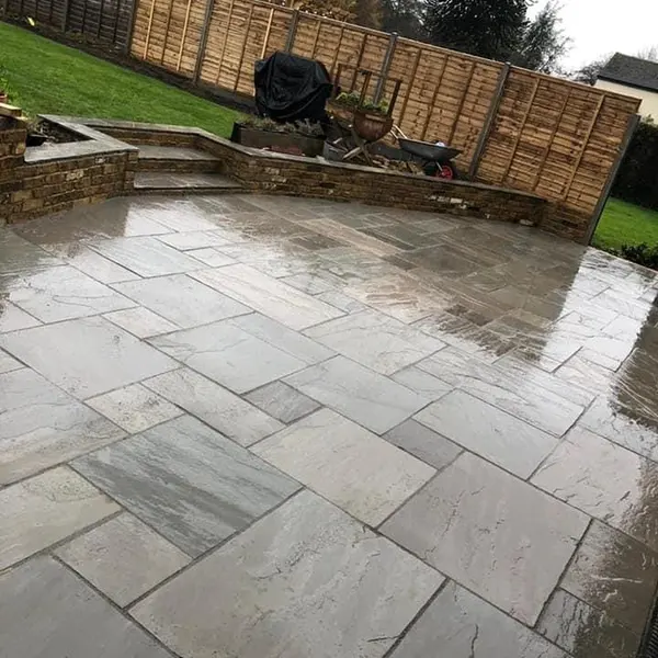 Grey slab patio in a walled garden