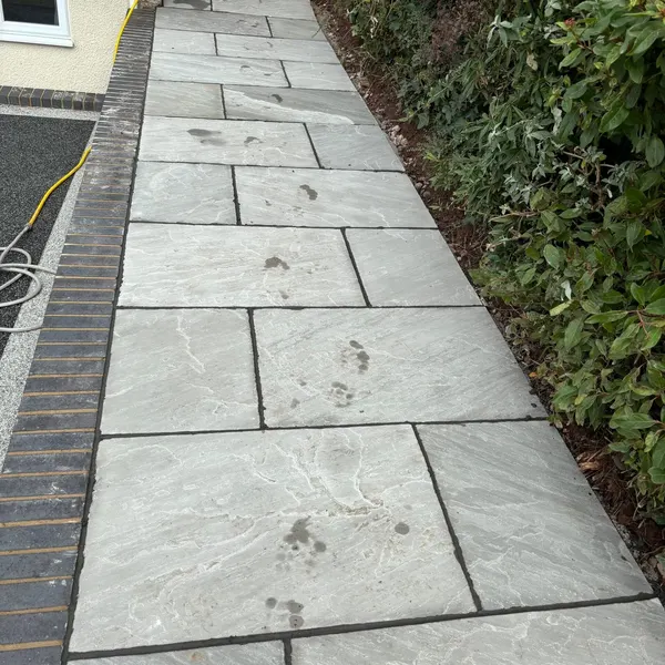 Grey slab path with a brick edge