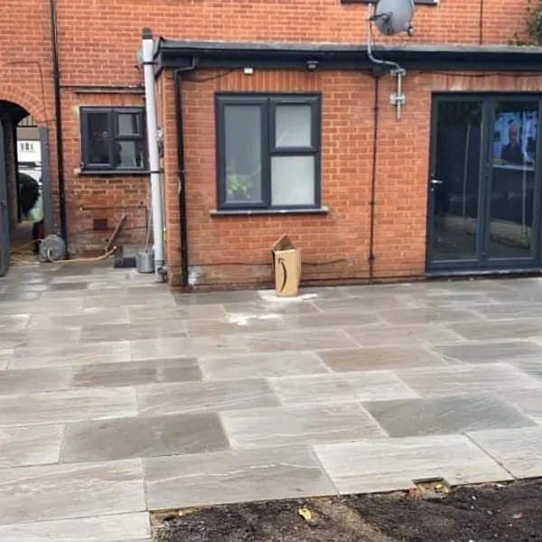 Grey slab patio behind a house