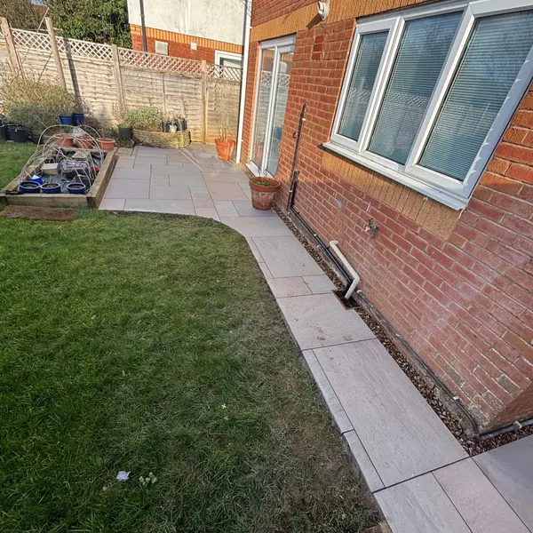 Slab patio wrapping around a house