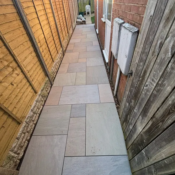 Narrow slab path down the side of a house