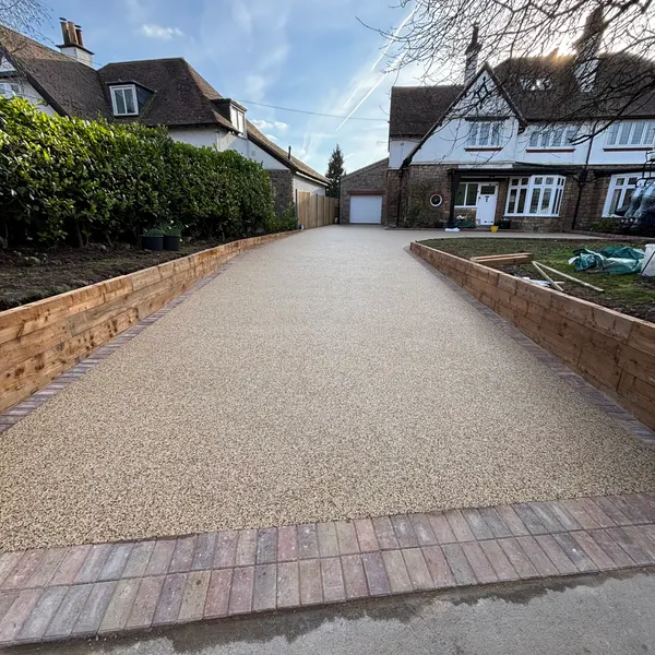 Resin bound driveway lined with low brick walls