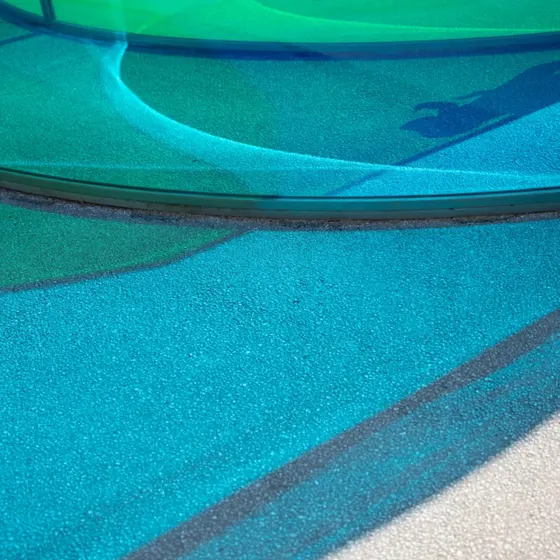 Blue rubber surfacing around a splash area