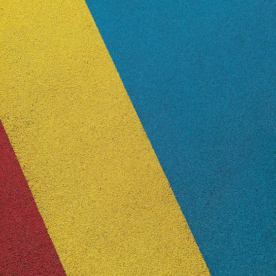 Rubber sports surface in yellow, red and blue